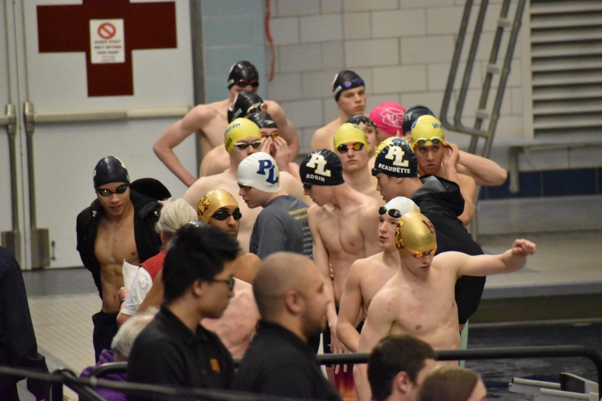 LINING UP. The four swimmers line up at the end of the pool directly before their race. The team, made up of SPA seniors Rishi Bhargava and Connor Overgaard, Highland Park senior Fred Myers and Highland Park junior Jon Bailey-Zimmerman, broke the SPA and Highland 200 medley relay record at sections. Their time was 1:39.65.