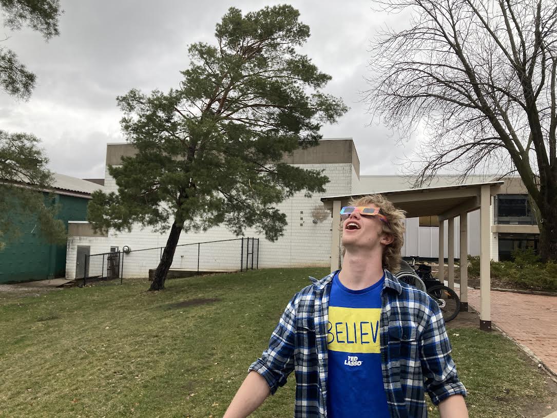 ANYTHING OUT THERE? Senior Connor Overgaard looks up at the sunless skies in mock exuberance. 
