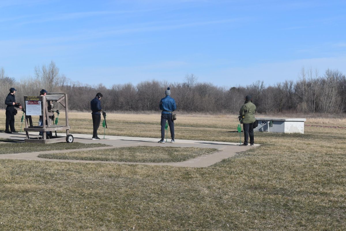 LOADED UP. Captain Johnny Rog (far left), freshman Kamran Janjua (mid-left), freshman William O’Brien (mid-right), and captain Louis Fratzke (far right) line up with their shotguns ready to fire.
