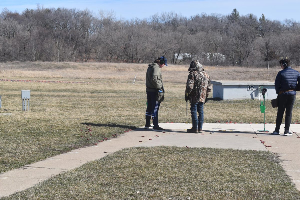 LISTENING UP. Freshman Axel Pearson listens to advice from his coach on his shooting.
