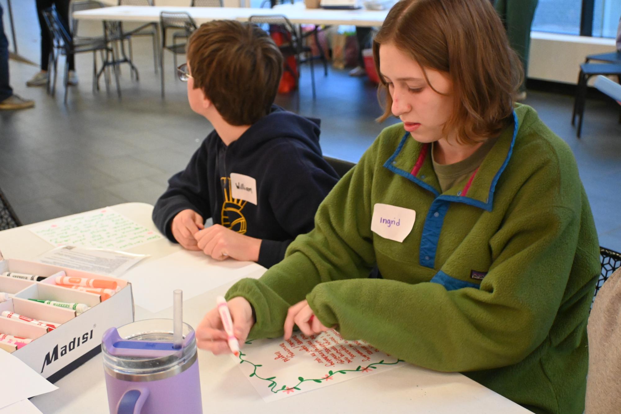 FLOWERS FROM THE HEART. Senior Ingrid Johnson adds a decorative outline dotted with flowers to her letter.