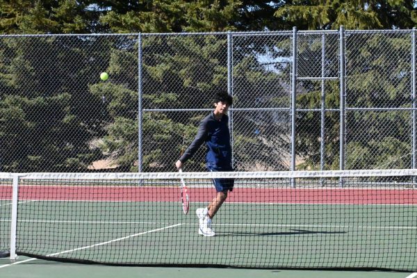 BACKHAND. Senior Baasit Mahmood hits a backhand stroke against the Mahtomedi Zephyrs towards the beginning of the game. The second match went on for more than two hours, with the Spartans losing 3-4.
