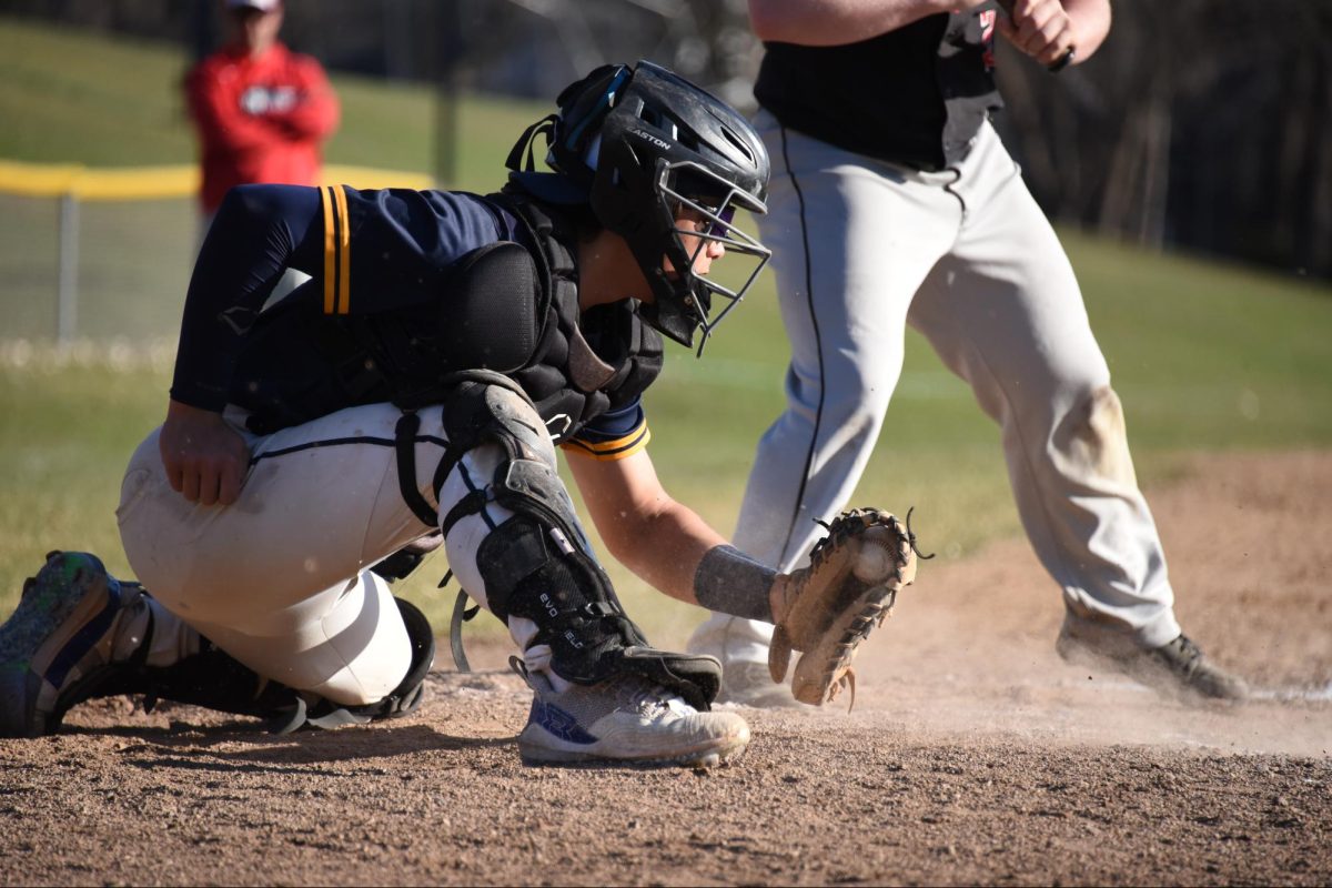 BEHIND THE PLATE. Schwab-Mahoney snatches the ball mid-air.  