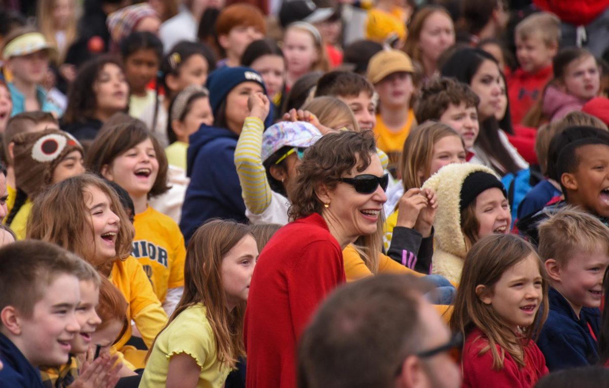 SMILES ALL AROUND. Lower school students smile as some seniors show off their dance moves on the way to high-fiving the kindergarteners.