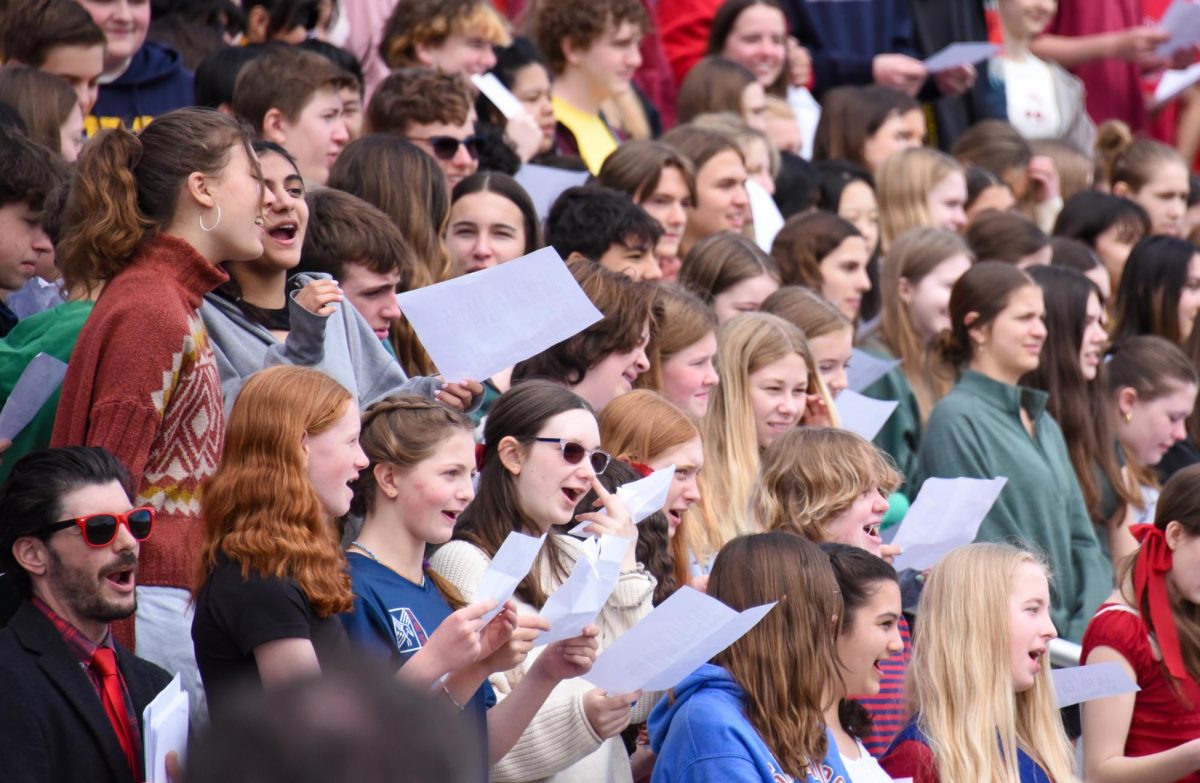 SING ALONG. High school and middle school students participate in singing the school song "Stand Up."
