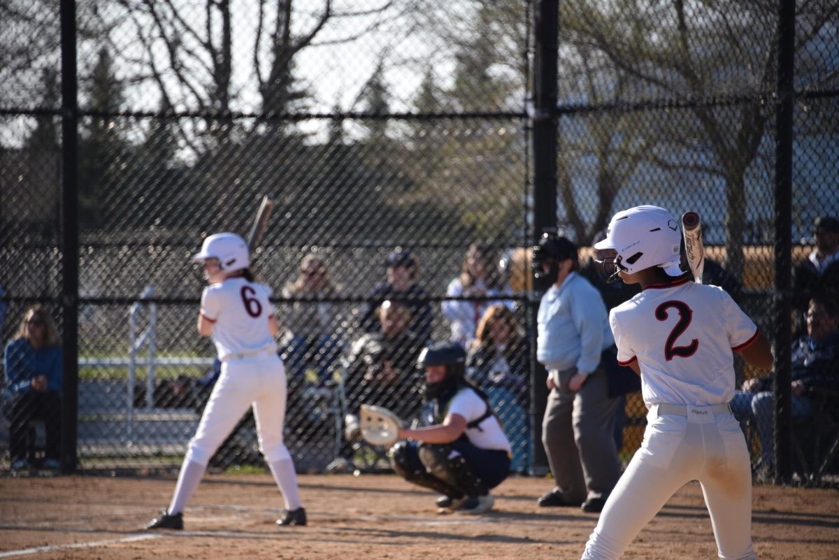 As Eliza Farley is at bat, Tamari Christopher warms up to be next at bat. 