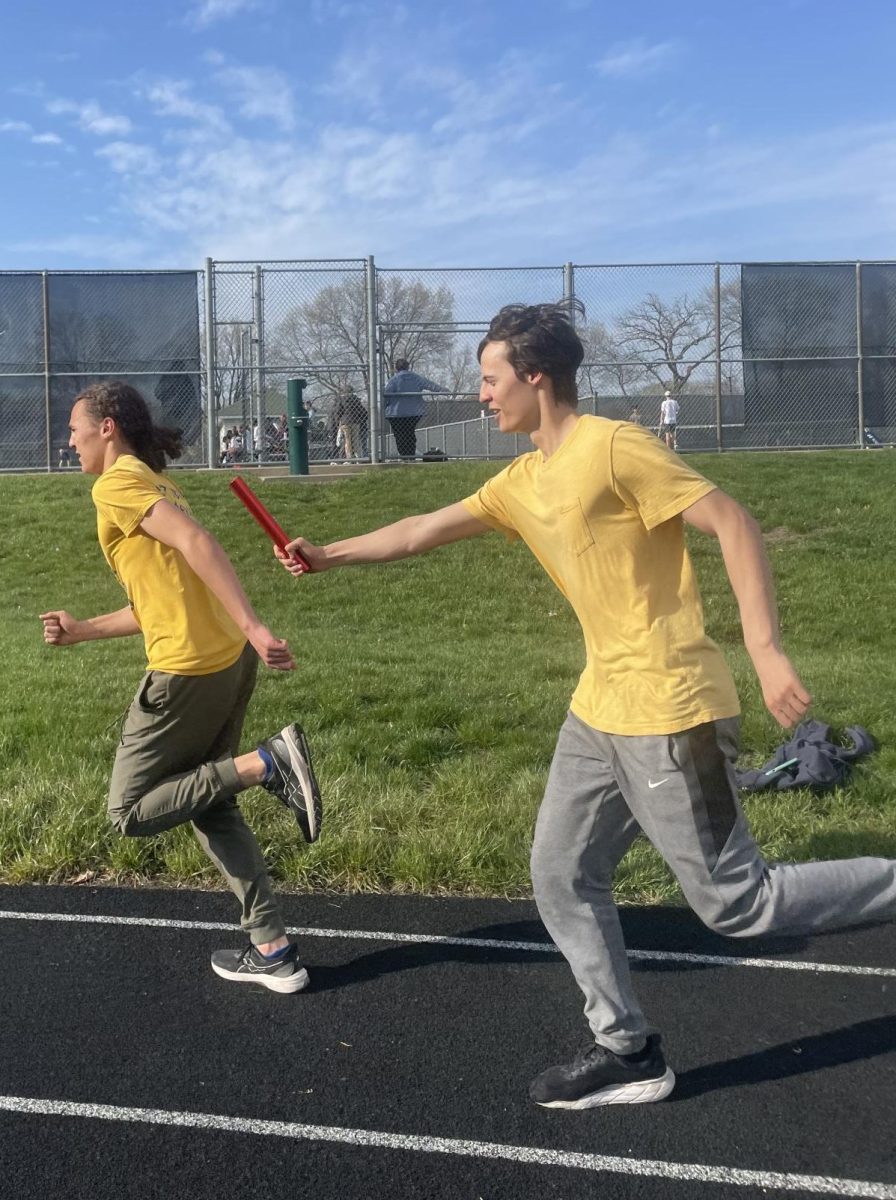 PRACTICE PARTNERS. Oliver Thompson passes the baton to his younger brother Langston at a track practice. The siblings have been on the track and basketball teams together. "I give him more direction than other people," Oliver said.