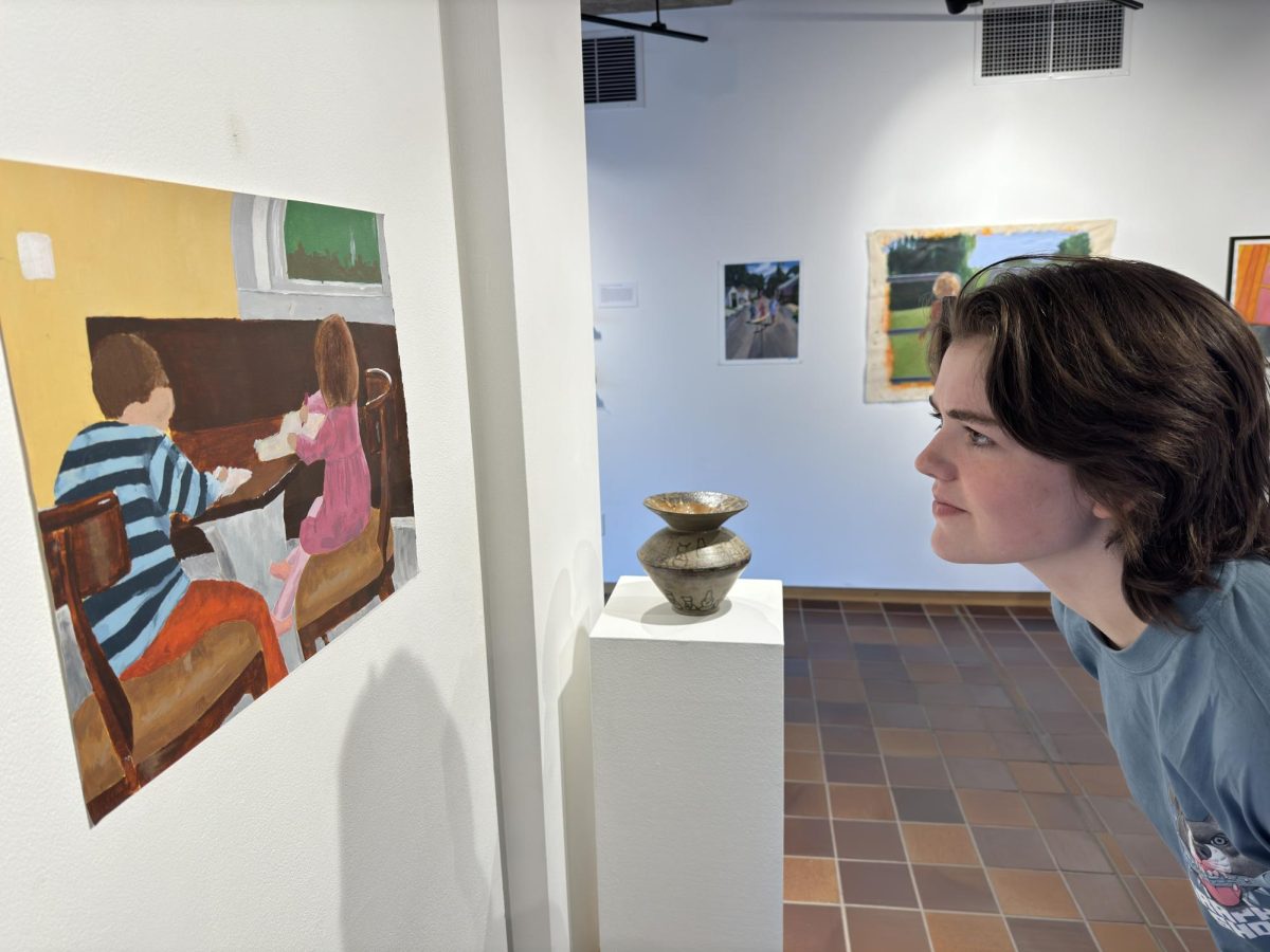 LOOKING CLOSER. Bridget Keel looks intently at Janes Higgin's Arcylic painting of her and her brother when they were younger. 