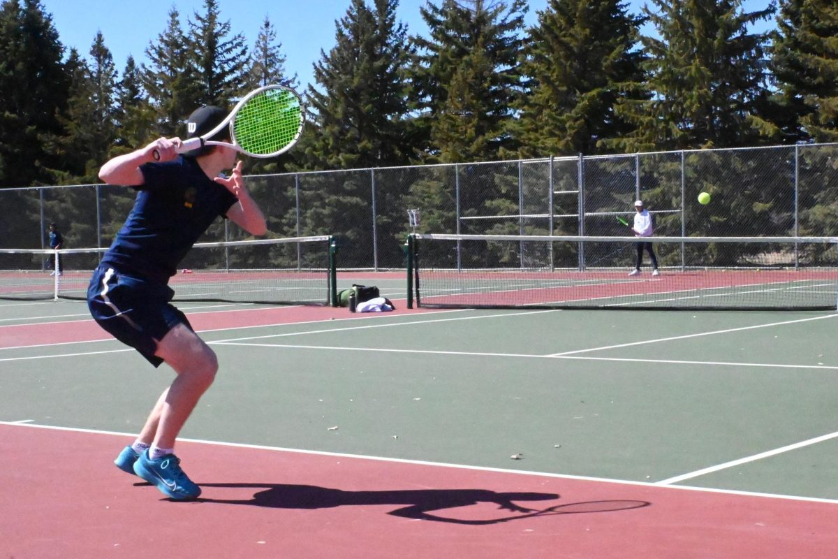 SPLIT STEP. Junior David Schumacher prepares to hit a forehand stroke against the Mahtomedi Zephyrs. During his second set, the scores were 2-6, 1-6 with a loss for the Spartans.