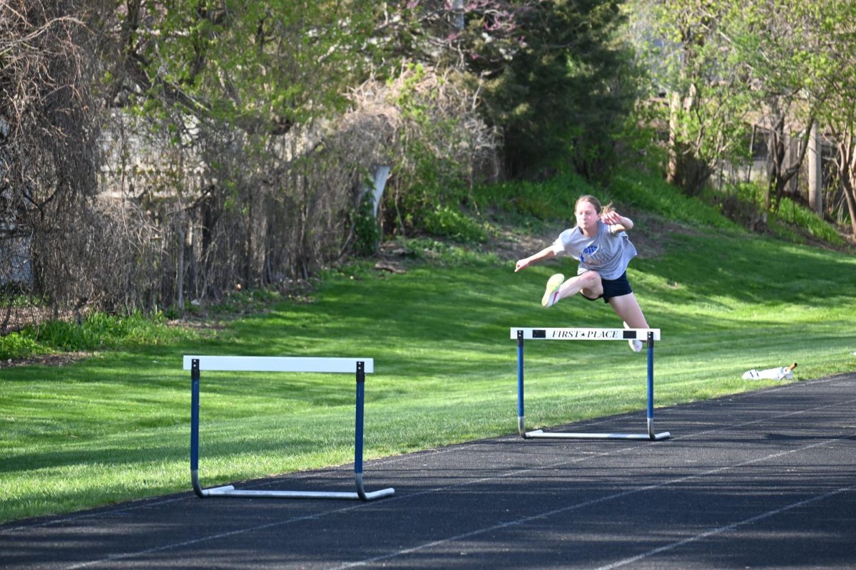 PRACTICE MAKES PERFECT. Elizabeth Tuttle practices for her next meet by leaping over the hurdles. Last year, Elizabeth qualified for state after she finished in second place in the 100m and the 300m hurdles.