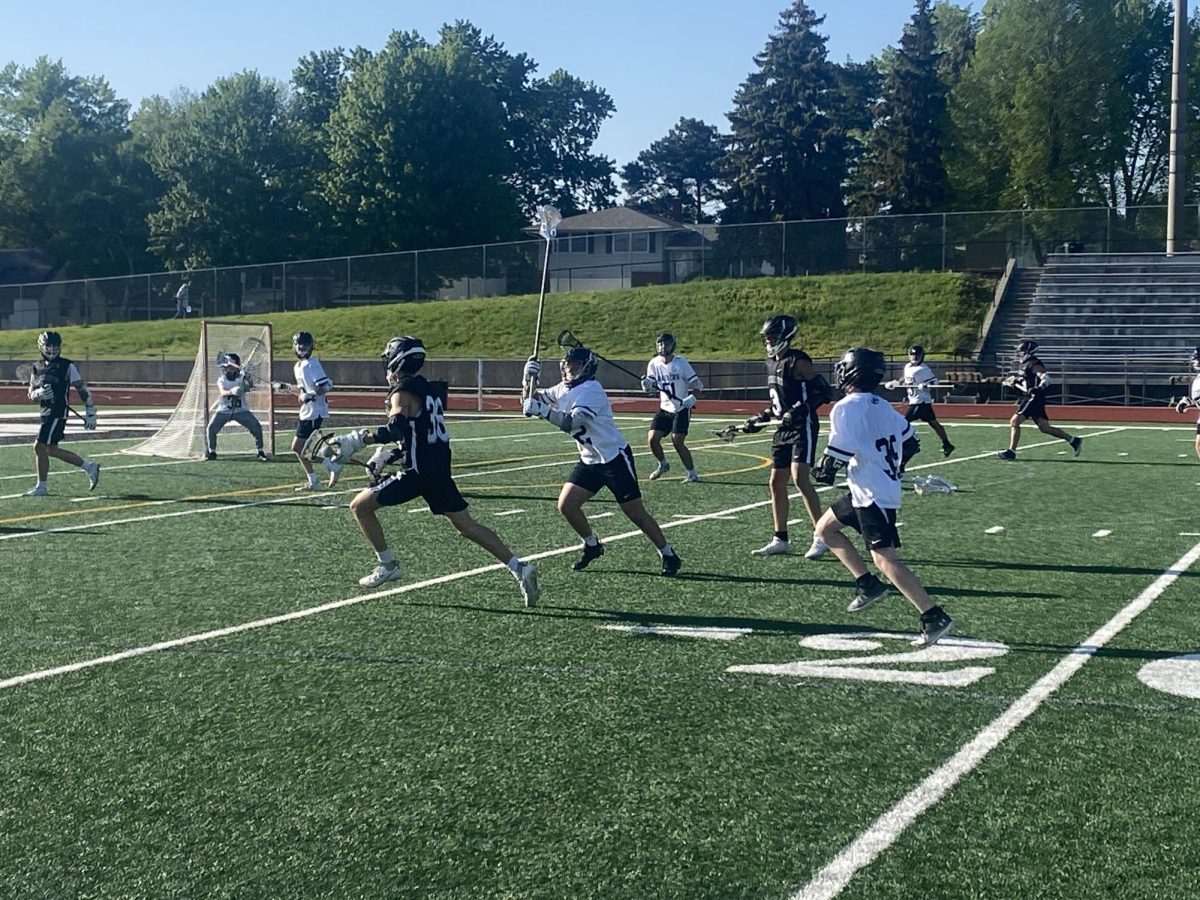 In Pursuit, A Roseville player chases after a Blackhawks player trying to get the ball.