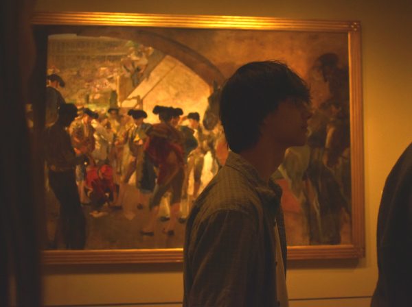 A PASSERBY. Milan Mishra strolls past one of the largest painting included on the tour. 