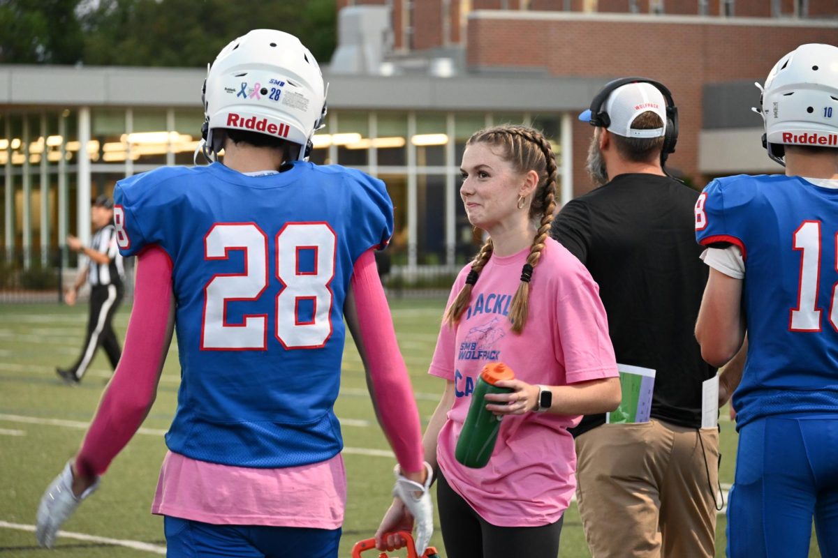TEAM MANAGER. Rivers chats with the team manager in between plays. 