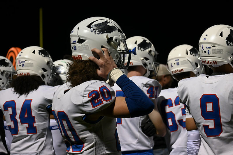 HELMETS ON. Junior Bennett Sauer puts his helmet on as he prepares to run back out on the field.