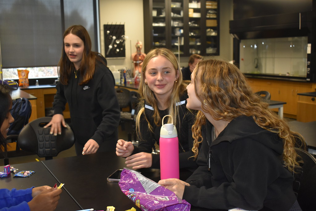 CLUB FUN. Ninth grader Louise Mahoney and junior Nora McKoy chat at the Community Action Service club