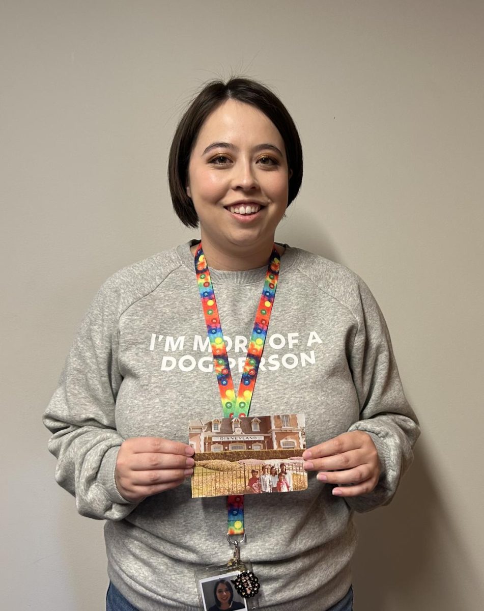 FROM THE REDWOOD FOREST TO 10,000 LAKES. LeMinh holds a photo of her family at Disneyland in California. Soon, her family would be sponsored and move to Minnesota.