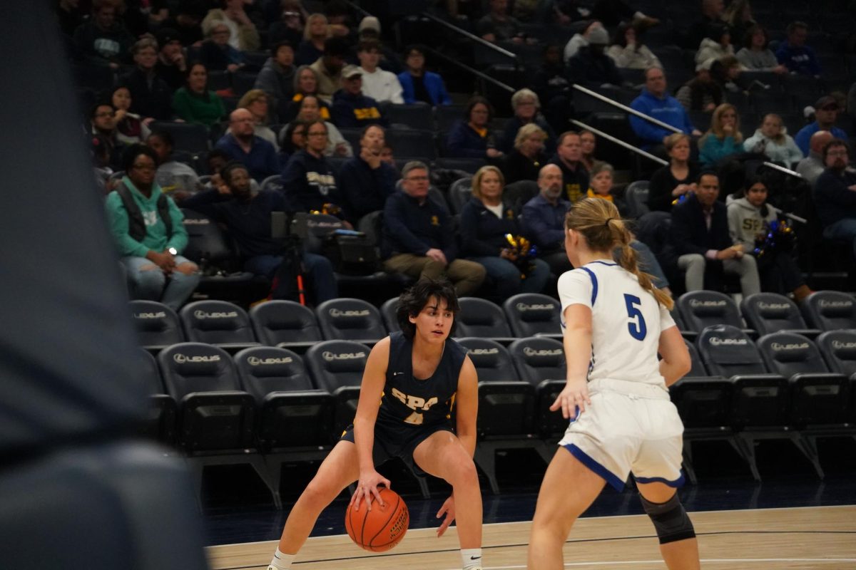 DRIBBLE. Junior Devi Nelson dribbles the ball between her legs to get around the MPA player. 