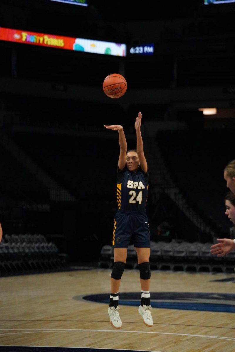 FORM. Senior Jules Taylor focuses on her form while shooting her free throw.