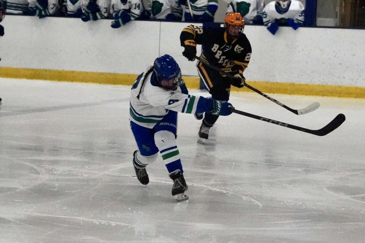 SHOTS FIRED. Sophomore Nova Stay from Blake shoots the puck in the first period, hoping to beat their conference rivals, Breck.