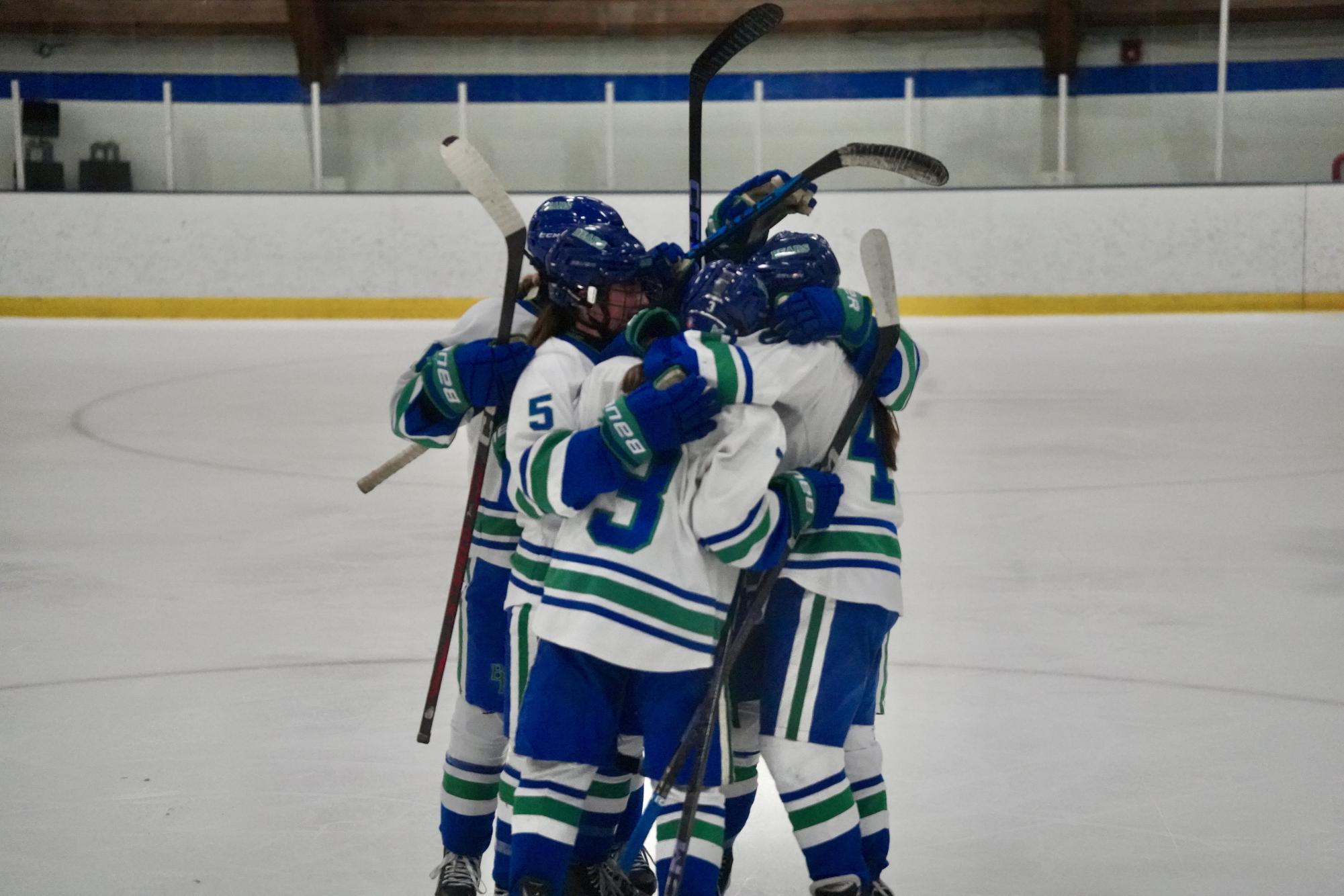 HUDDLE OF CELEBRATION. Blake players come together to celebrate and congratulate junior Ella Bond for tying up the game, making the score 1-1.