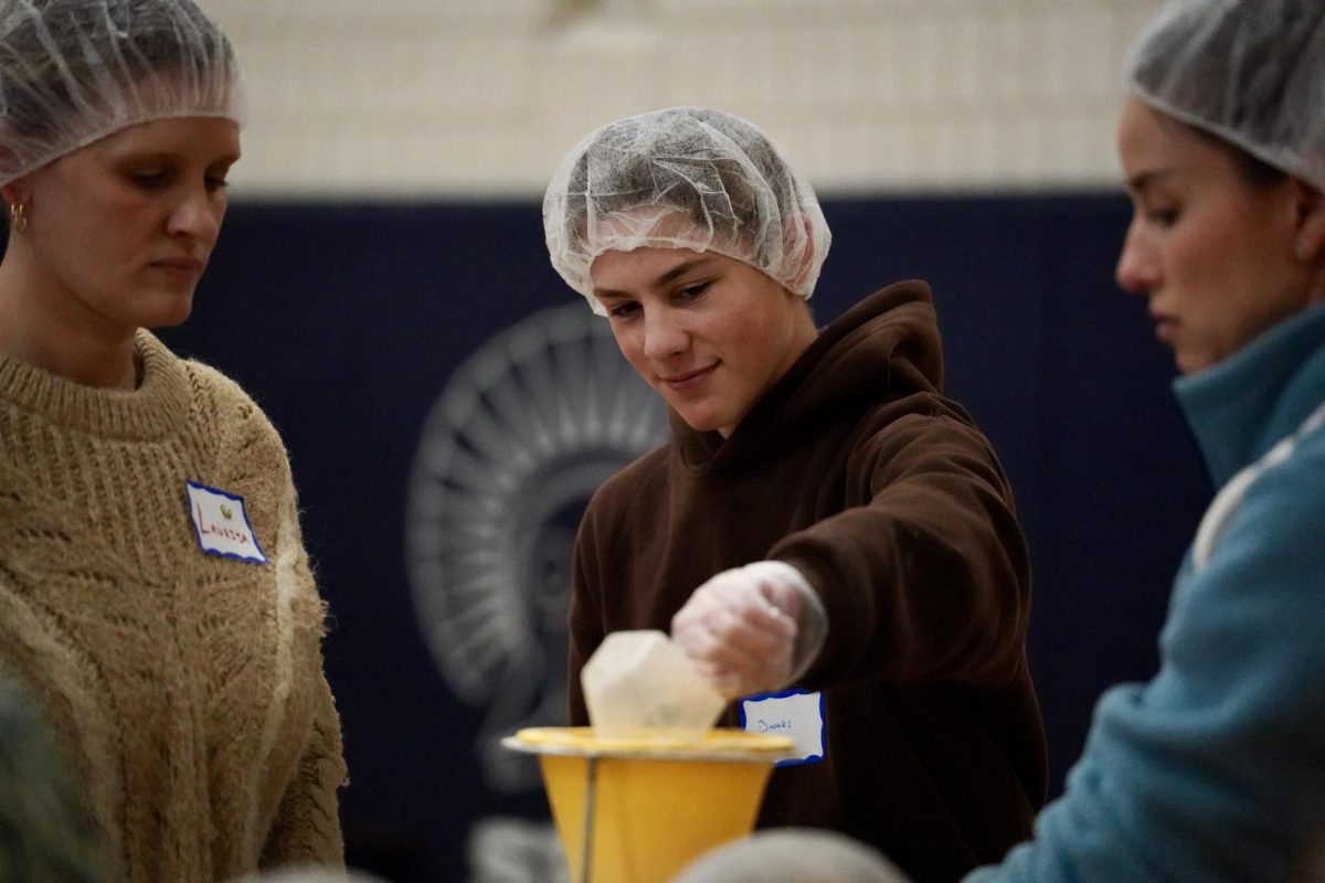 ALL SMILES. Sophomore Brooks Geiger enjoyed getting to give back to the community alongside his brother.