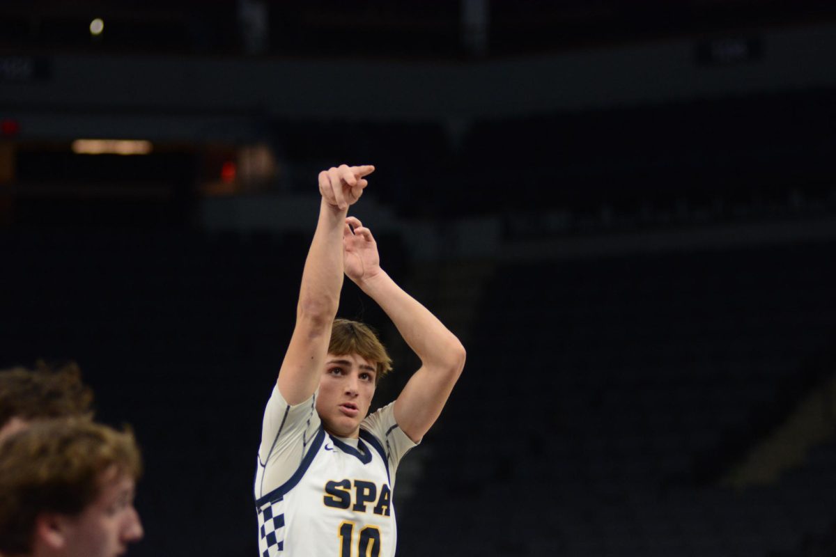 STRONG FINISH. Sophomore Miles Vogenthaler holds his finish after shooting a free throw.