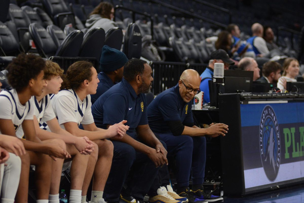 TEACHING. The basketball coaches sit and discuss the game.