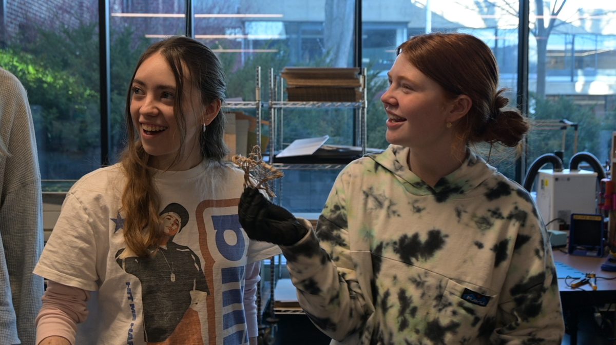 ALL WRAPPED UP. Seniors Ava Schluender and Liza Thomas show off their completed star.