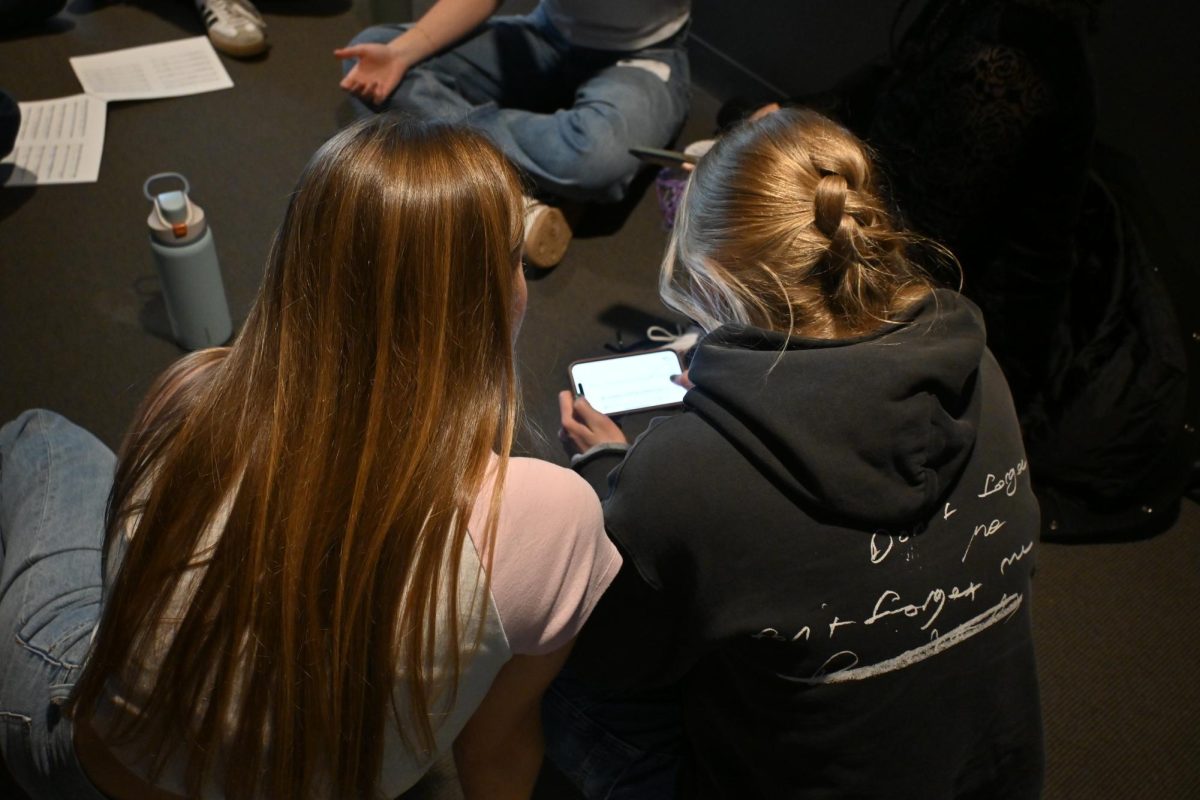 SHARING LYRICS. Senior Helen Townley shares lyrics with an acapella singer. 
