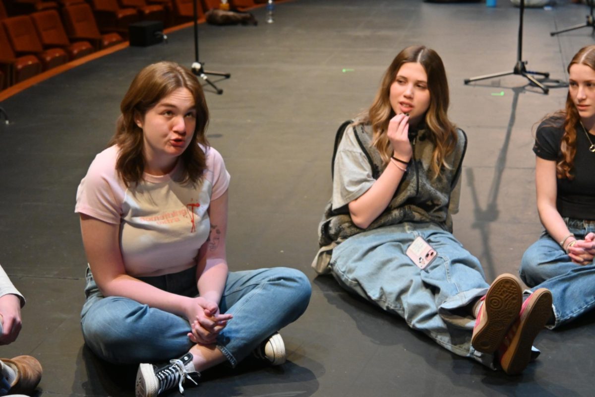 HIGH NOTE. Junior Jane Duback listens to a note demonstration. 