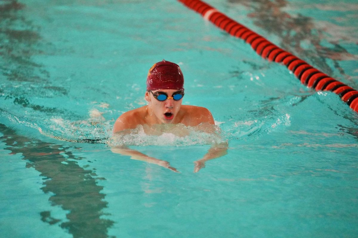 BREATHE. Highland swimmer is near the finish in his 100-yard breaststroke.