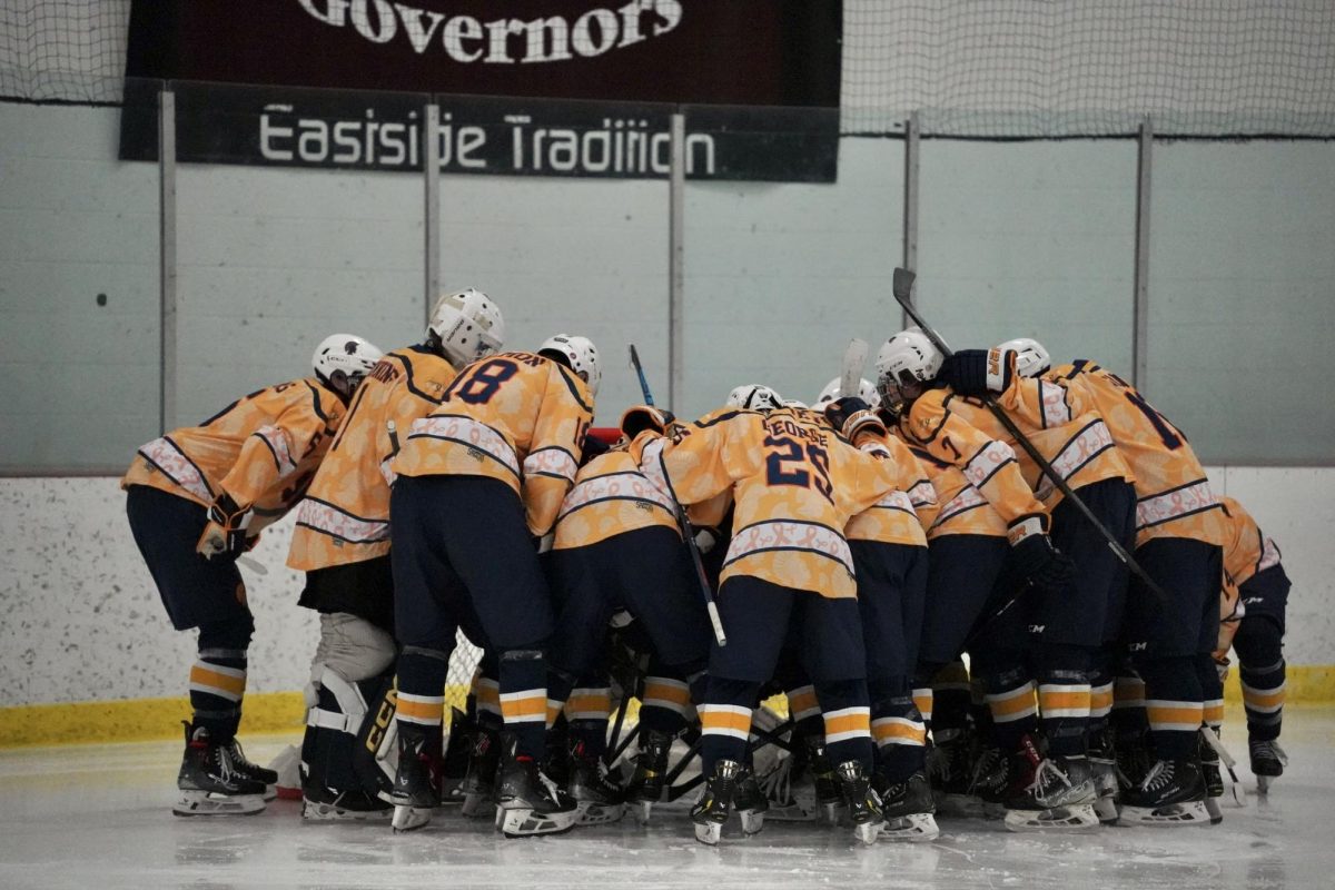 TEAM HUDDLE. The Spartans yell their chant before starting the game.