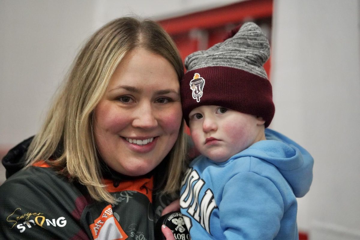 SHY SMILES. Two-year-old Sawyer Pearson shows up to the hockey game in her honor to do the ceremonial puck drop a day before her third birthday. 