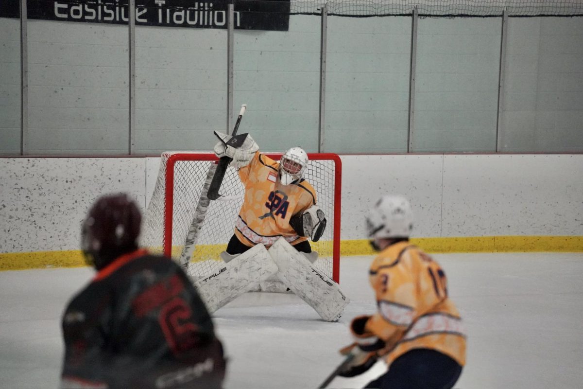 BLOCK. Junior Millie Farrington hits the puck up to keep the play alive.
