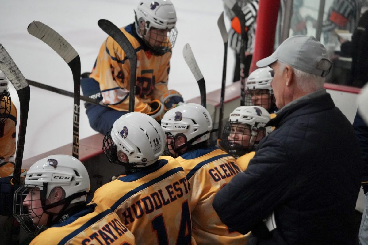 TEAM TALK. The team comes together to regroup before going into the third period after the Governors tied up the game during the second period.