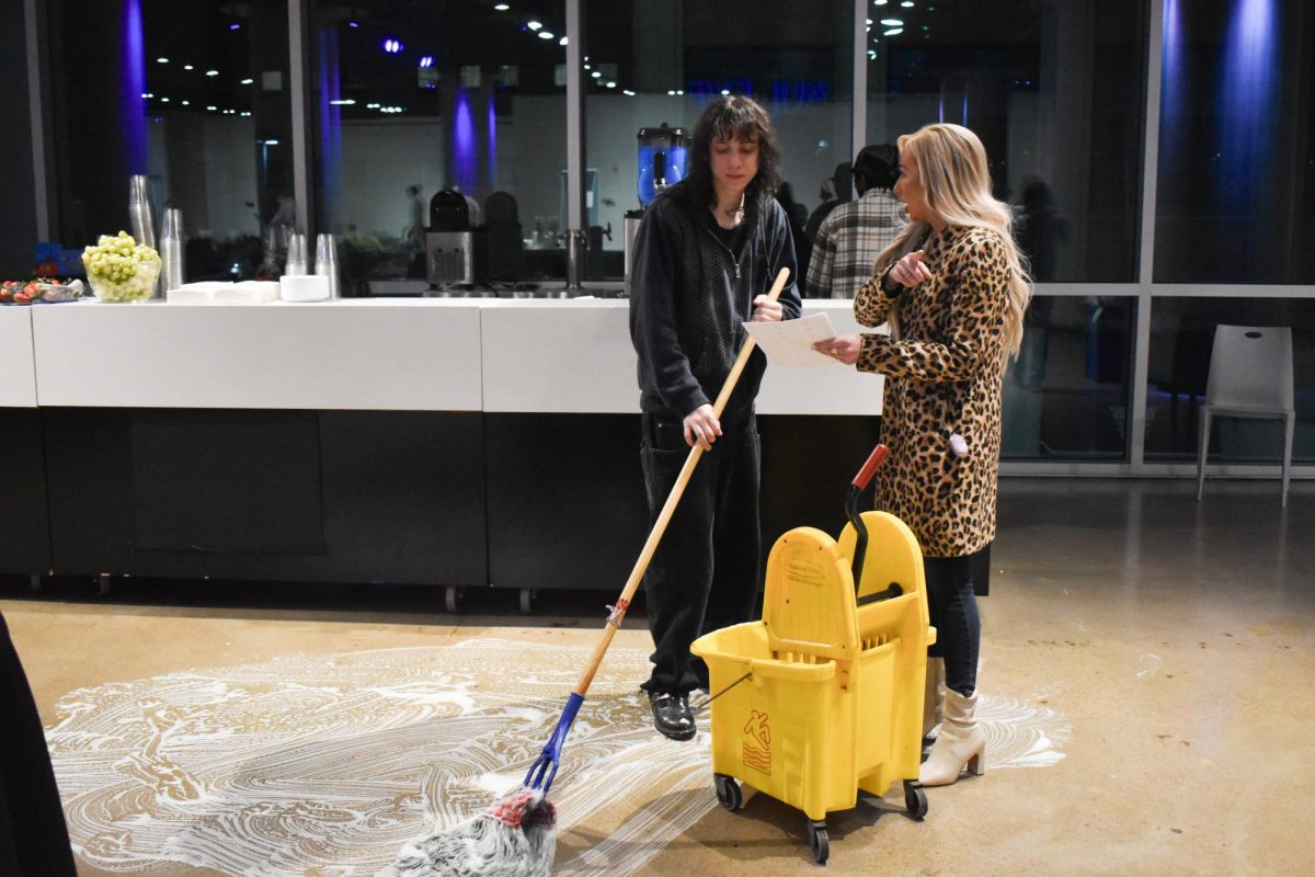 SPEED CLEAN. St. Paul Event Center staff members work quickly to use strong cleaners to clean up the mess on the floor from the broken slushy machine just in time before the doors opened. 