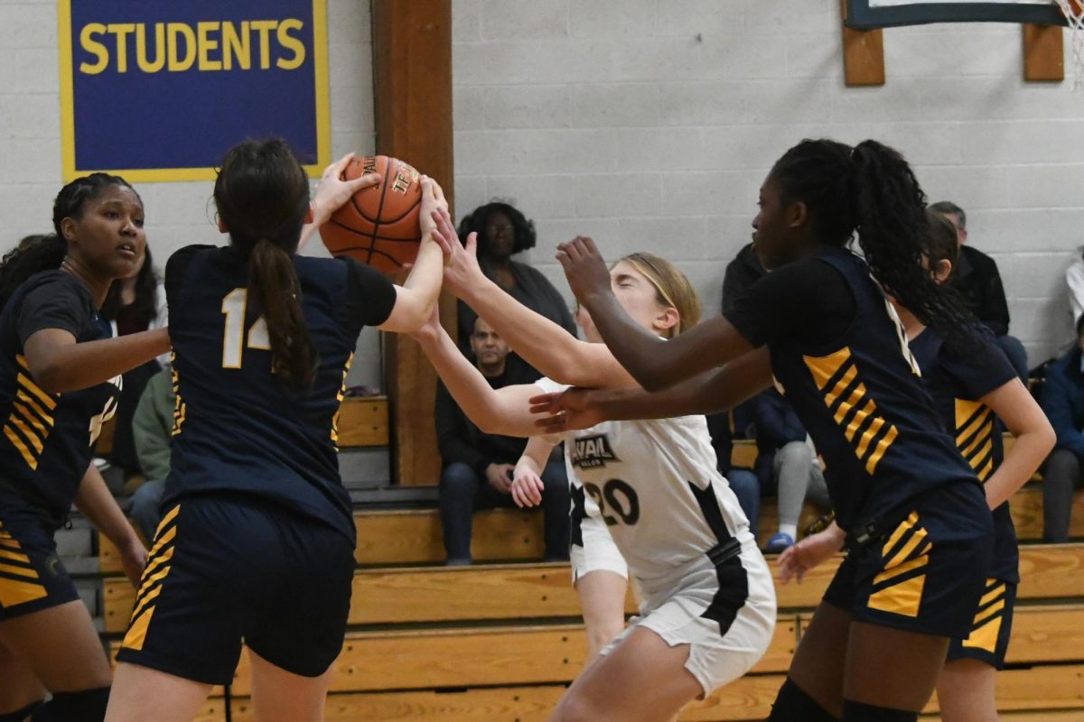 INTERCEPTED. Four Spartans rush over to block player number 20's shot once she entered the zone defense. 