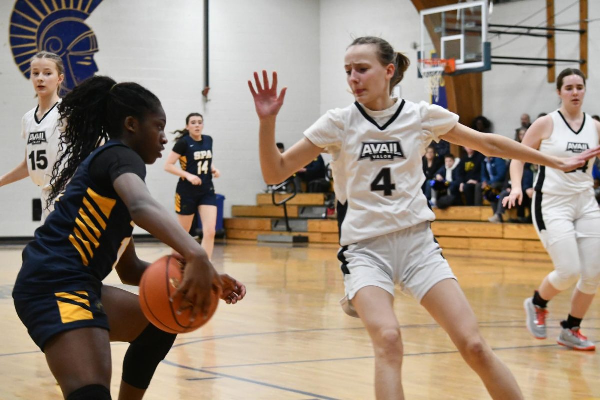 CROSS-OVER. Sprinting right down the center of the court, 7th grader Obi-Walker suddenly does a cross-over to get around player number four. This is a common drill the Spartans do during daily practices leading up to games. "I liked our energy during the game," said Obi-Walker.