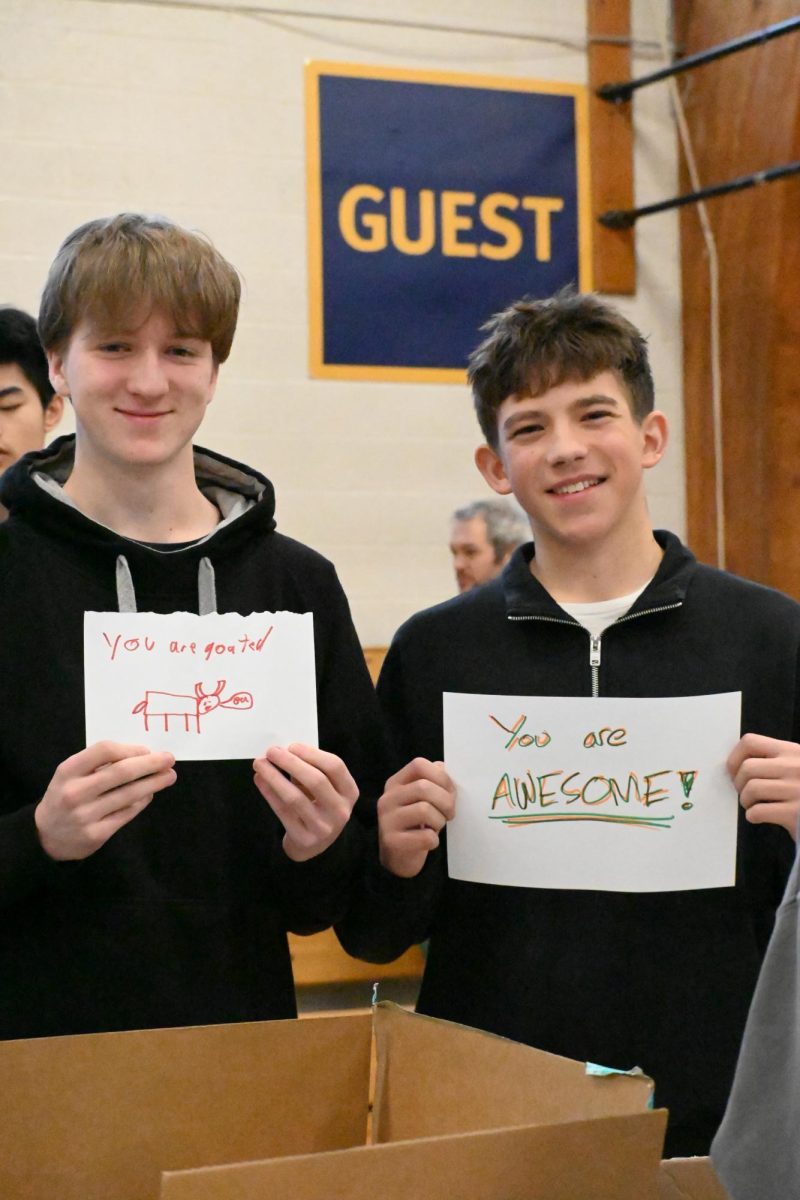 READY TO GO. Juniors Jesse Wussler and Miles Atkinson pose with the encouraging messages they placed in their hygiene packages.  
