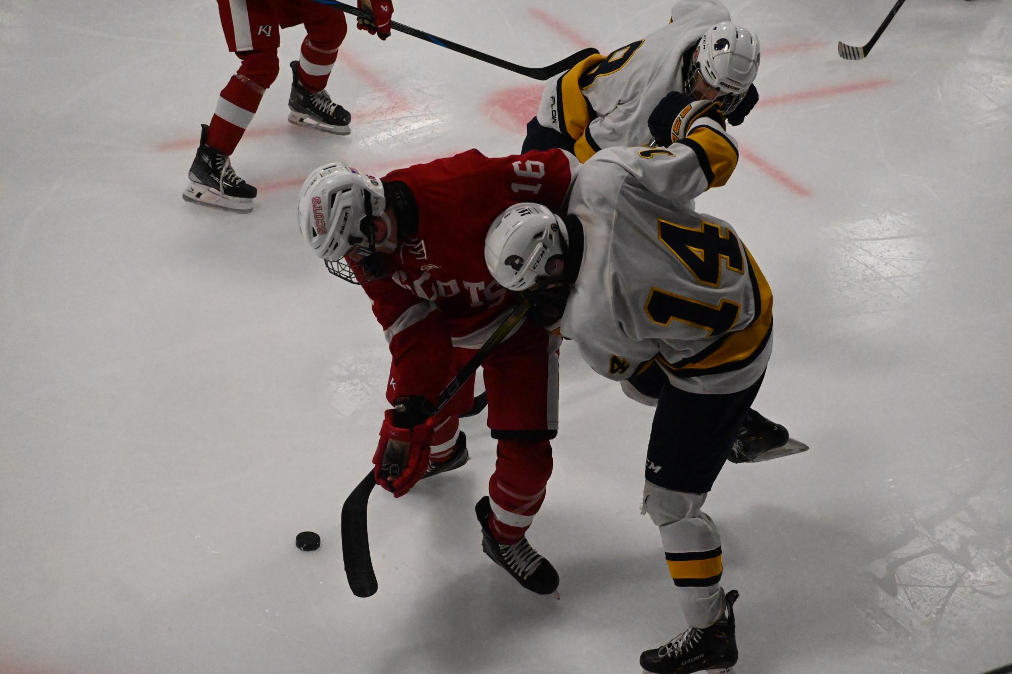 BATTLE. Liam Huddleston battles a Highland Player for the puck.