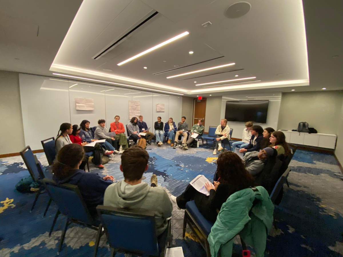 DELIBERATION. The workshop discusses the pros and cons to different solutions for poverty.