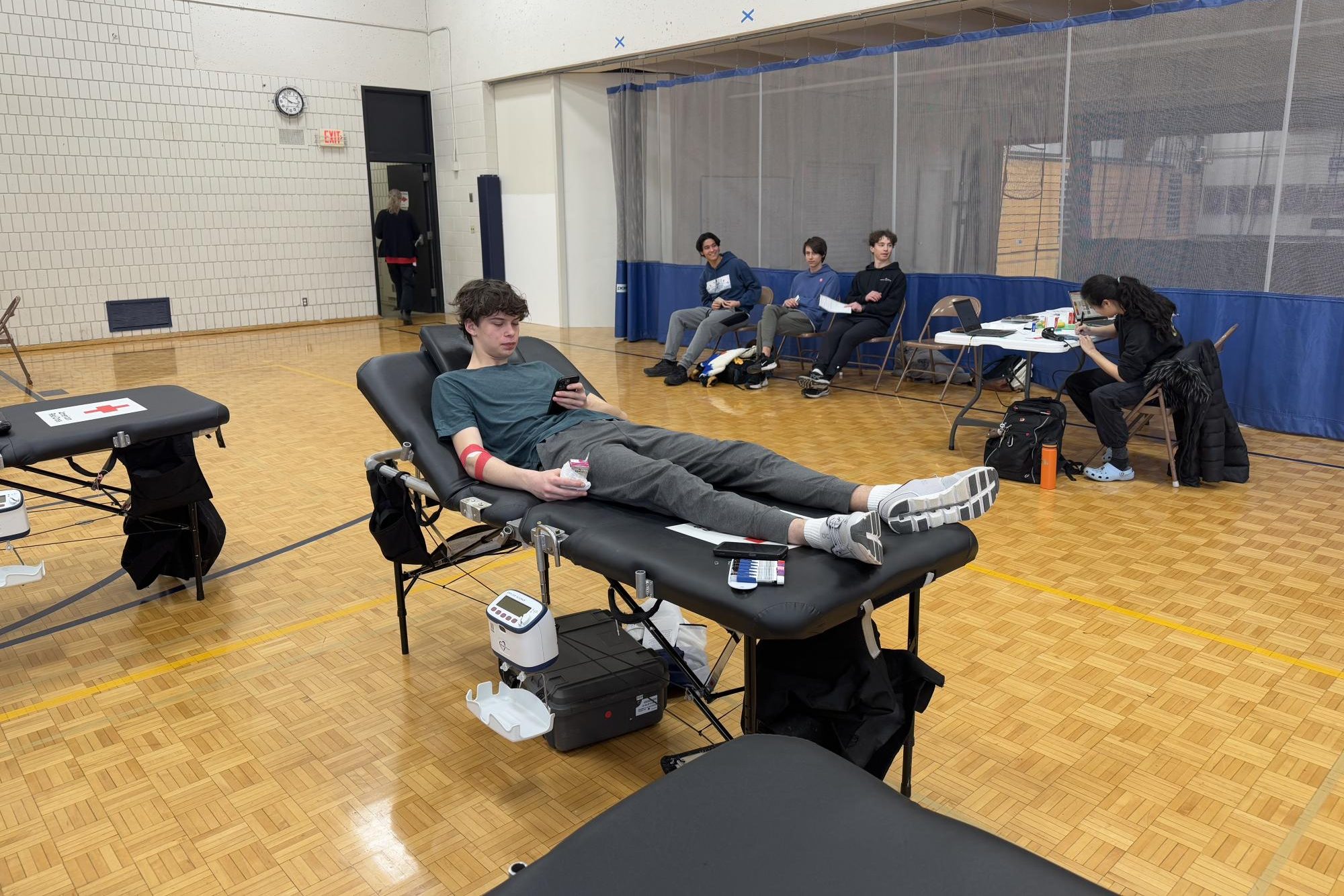 GIVE BACK. Senior Isidor Valdez eats a snack on a donor bed after giving blood.