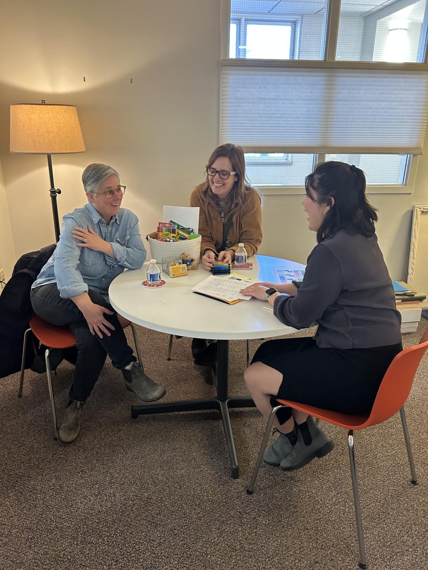 LAUGHS AND FUN: Anna Northenscold meets with a family looking at Saint Paul Academy as a school option for their kids. Passing through the offices laughing and work is easily audible. The office setting is fun and engaging, a great way to welcome new families.