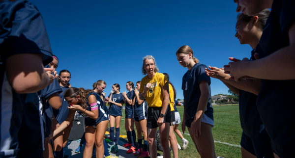 PREGAME HUDDLE. First-year Lucy Lowman pays attention to her coach's words moments before kickoff. She appreciates the support and motivation her coach provided throughout the season. 

Photo taken from SPA SmugMug.