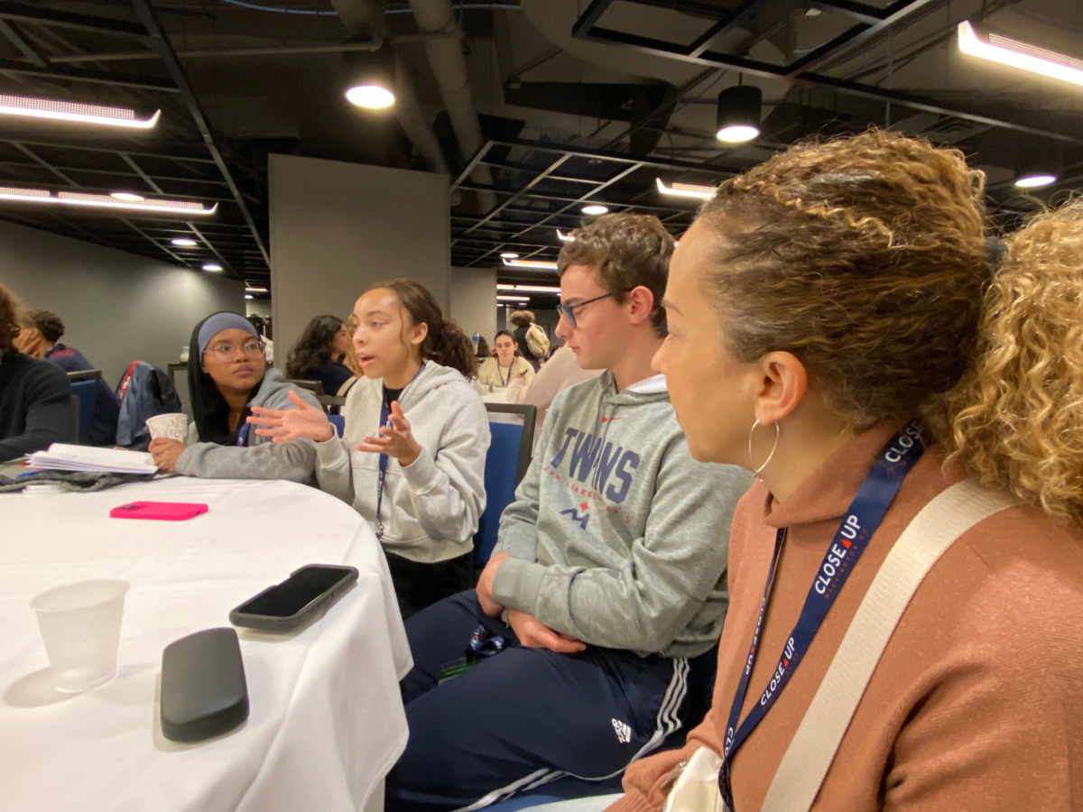 TABLE TALKS. The SPA cohort presents their plan to address poverty in the Twin Cities to the advisors and other students at the table.