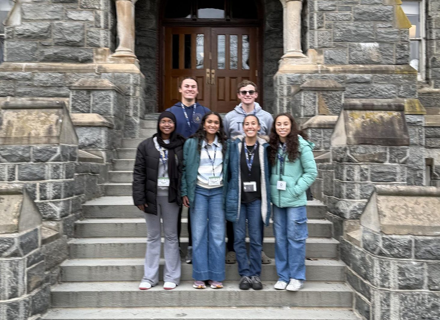 CAMPUS TOUR. (From top to bottom, left to right) Sophomore Langston Thompson, junior James Welsh, sophomore Anessa Herzi, sophomore Nabeeha Qadri, senior Raven Glaser and senior Julia Taylor stand on the steps of Healy Hall at Georgetown University.