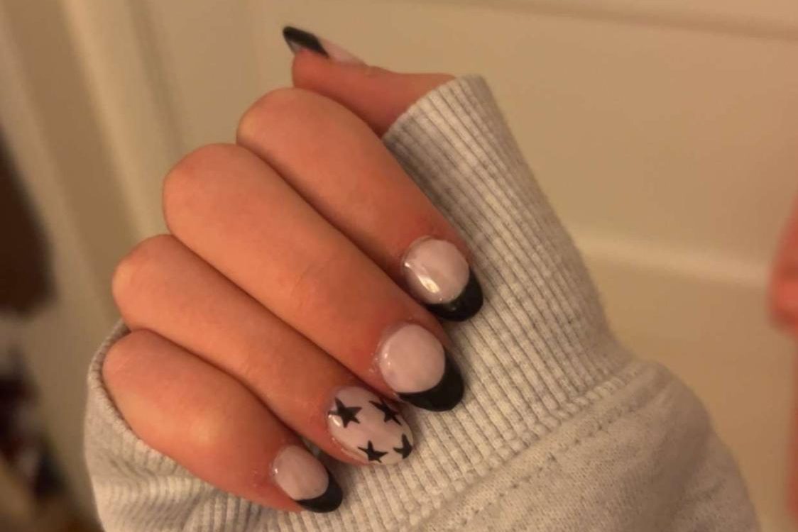 FINISHED PRODUCT. Huelster shows her newest set. She did black french tips with a starry design on the ring finger. The set is elegant and will match with her outfits. 

Photo submitted by Zoe Huelster