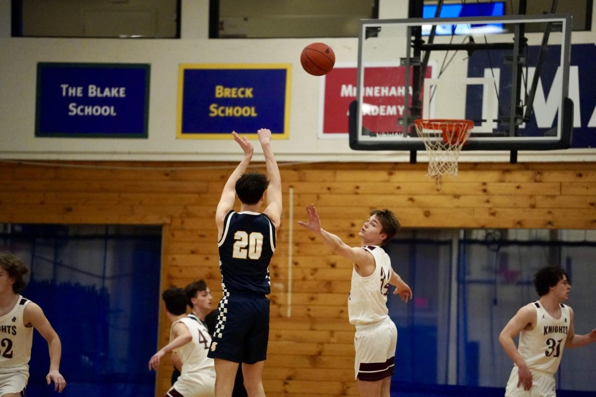 DEFENDERS CLOSING IN. Senior Nathan Rock takes a shot while Nova's defenders close in on him. 