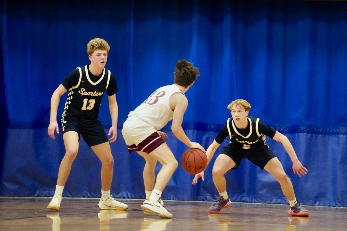 D-UP. Sophomore John Grimsurd and Junior Ben Sieben have their eyes on the ball to defend.