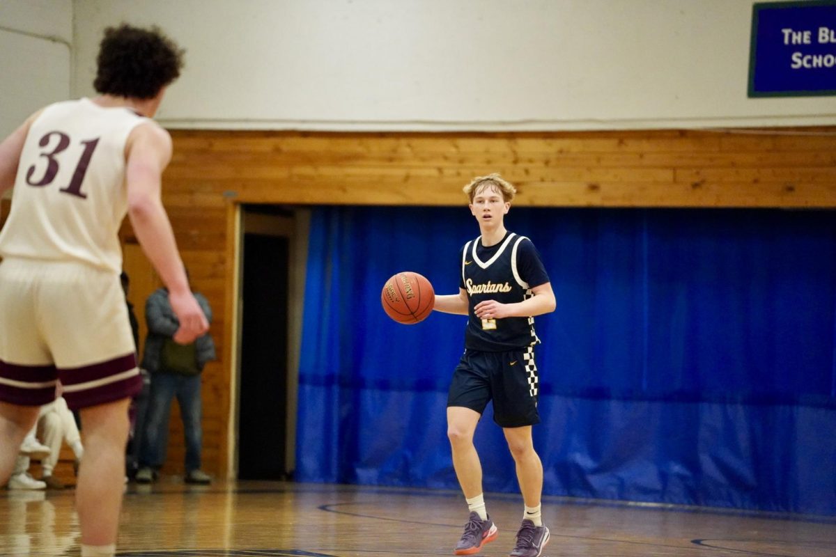 POINT GUARD. Junior Ben Sieben dribbles the ball up the court. He looks for his teammates to pass the ball to to initiate their offensive plays. 